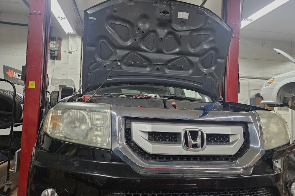 Japanese Auto Repair in Racine WI At Durand Automotive. Honda vehicle with open hood inside a Japanese auto repair shop